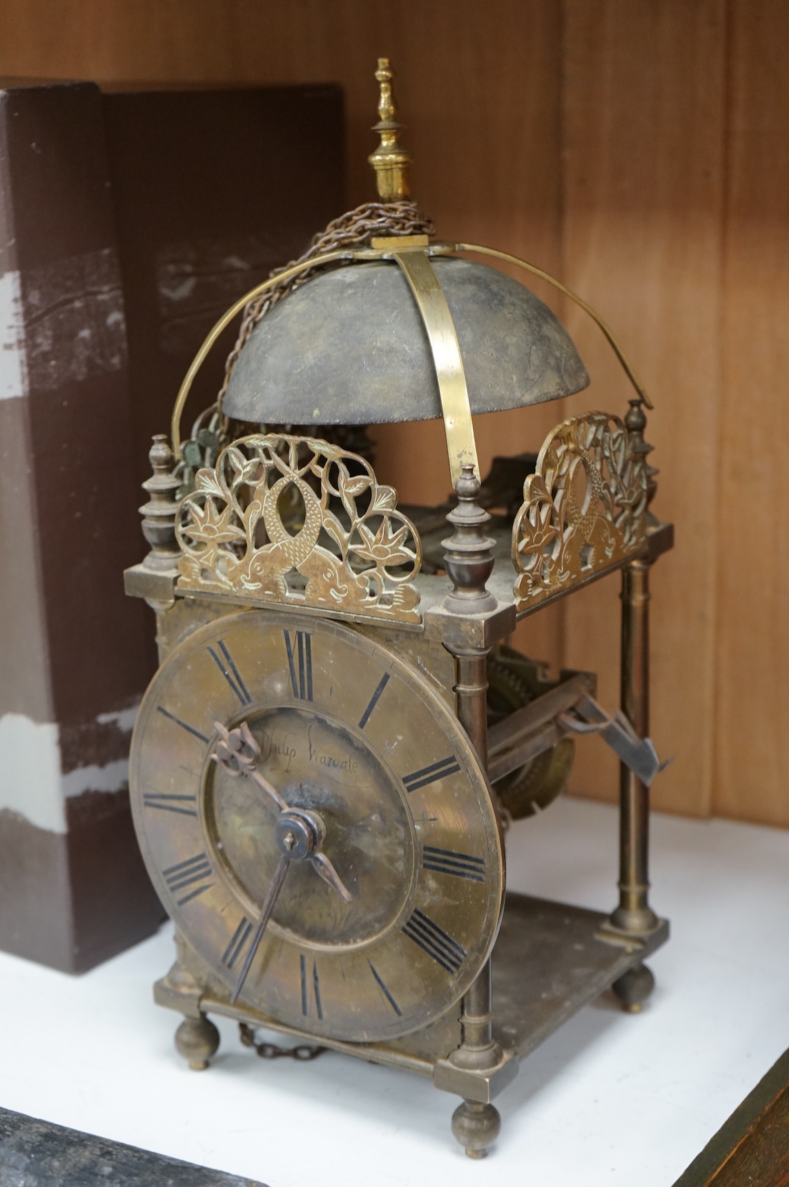 An 18th century lantern clock with pendulum and weight, the dial inscribed Philip Wardale, 37cm high